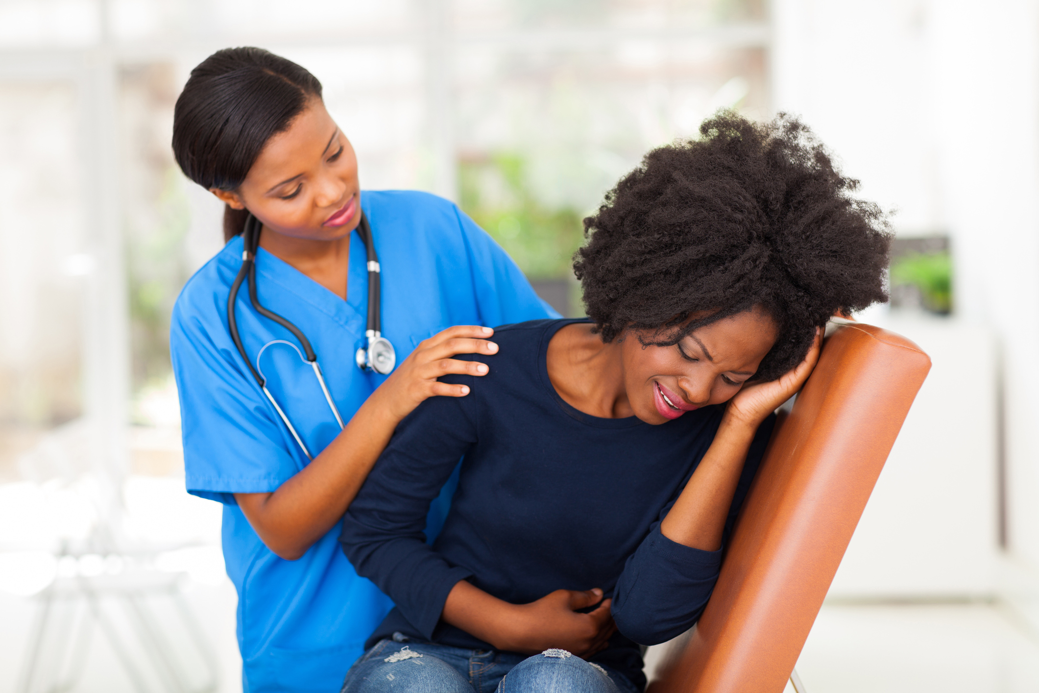 Nurse comforting patient with gastrointestinal issues Nurse comforting patient with gastrointestinal issues