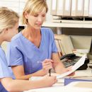 Charge Nurse helping a staff member  Charge Nurse helping a staff member