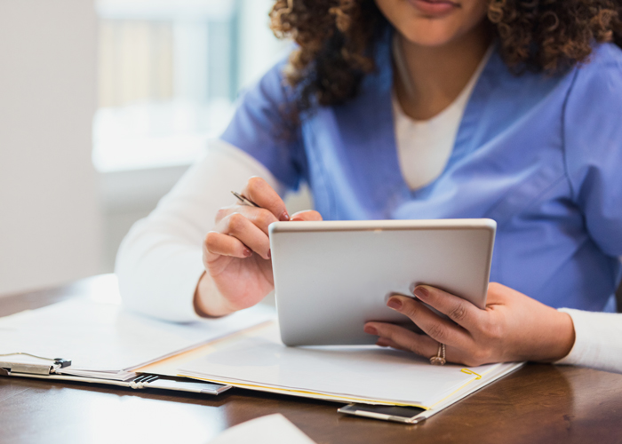 Nurse working on a tablet Nurse working on a tablet